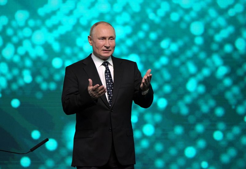 Russian President Vladimir Putin takes part in a conference in