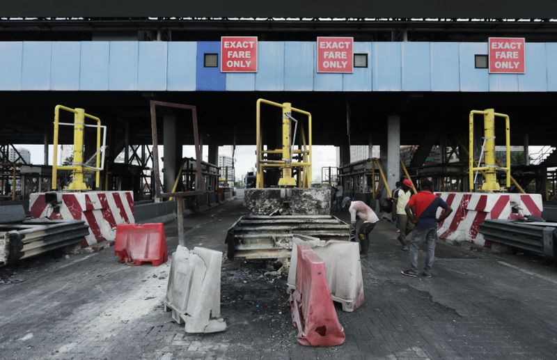 Workers clean up the Lekki toll gate in Lagos