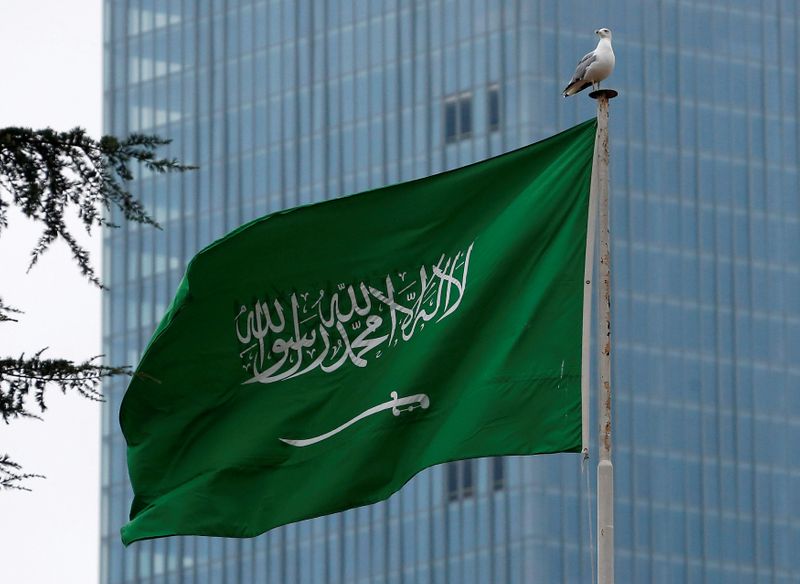 FILE PHOTO: A Saudi flag flutters atop Saudi Arabia’s consulate