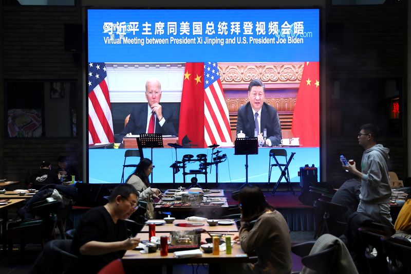 FILE PHOTO: Screen shows Chinese President Xi Jinping attending a