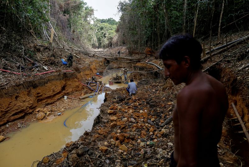 FILE PHOTO: A Yanomami indian follows agents of Brazil’s environmental