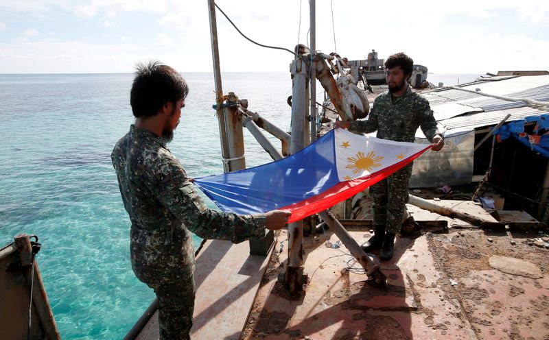 FILE PHOTO: Philippine Marines fold a Philippine national flag during