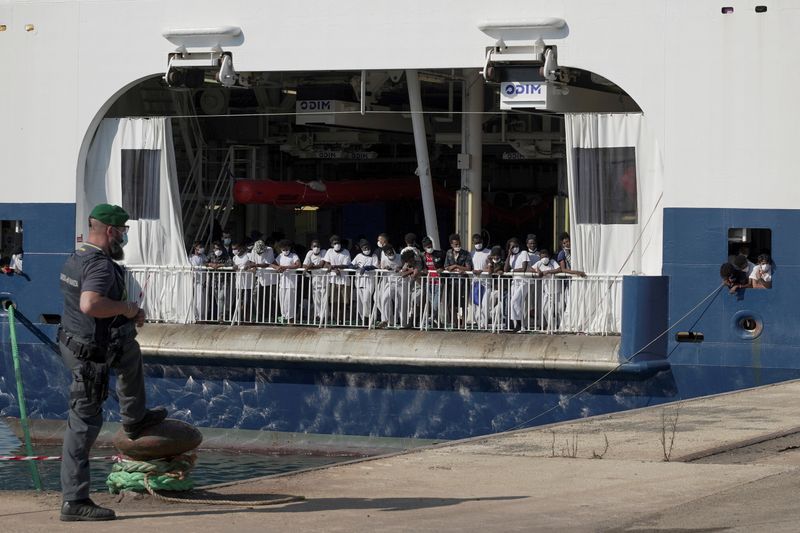 FILE PHOTO: Migrants wait to disembark the ship ‘Geo Barents’