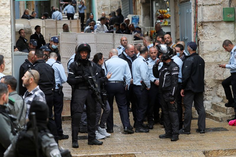 Top Israeli police officials gather near the site of a