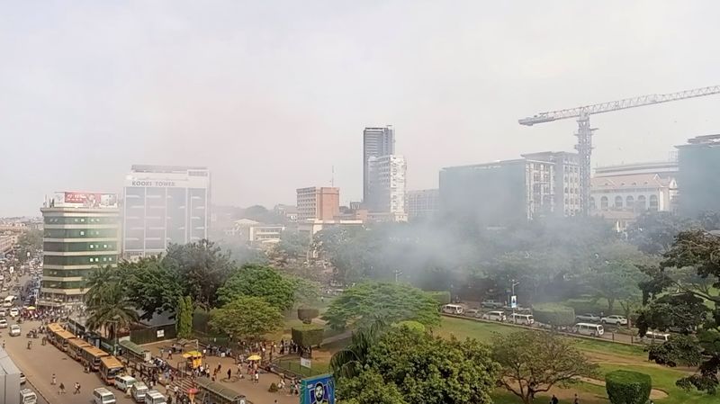 Smoke rises near the blast area, in Kampala