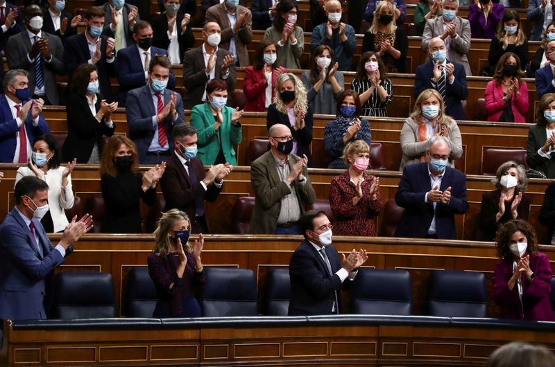 FILE PHOTO: Deputies applaud after 2022 budget vote in Madrid