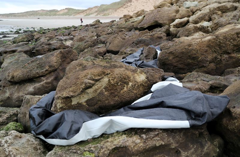 A damaged inflatable dinghy is seen near the Slack dunes