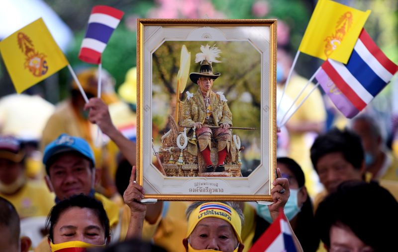 FILE PHOTO: A person holds a portrait of Thailand’s King