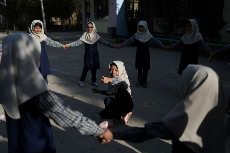 FILE PHOTO: Afghan girls attend school in Kabul