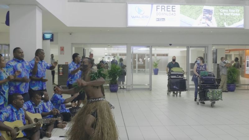 Performers greet travellers in the terminal upon arrival at Nadi
