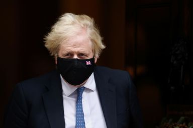 Britain’s PM Johnson walks outside Downing Street in London