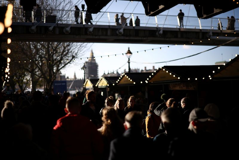 People walk through a Christmas-themed market on the South Bank,