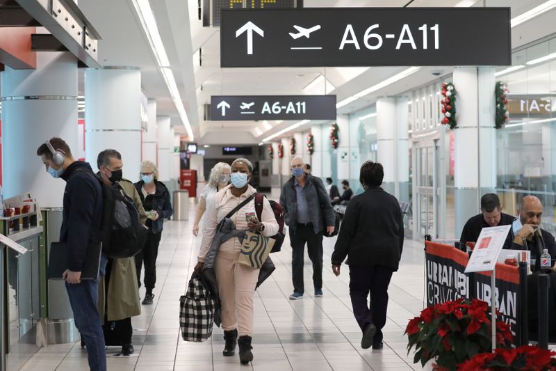 United States-bound passengers walk in Toronto Pearson Airport
