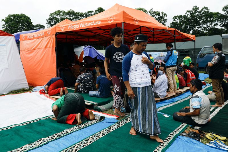 Friday prayers at a temporary shelter in Penanggal, Candipuro district,