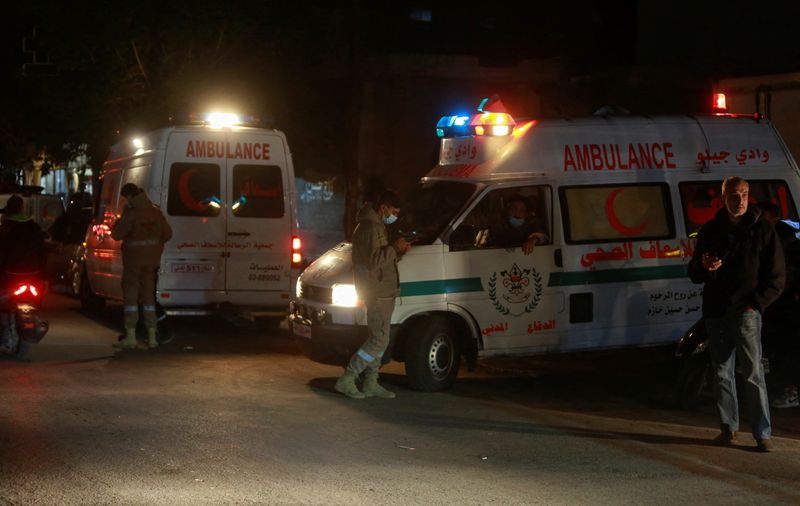 Ambulances are parked at the entrance of the Palestinian camp