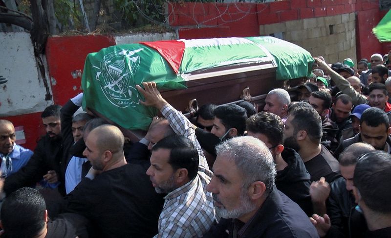 Men carry the coffin of a man during his funeral