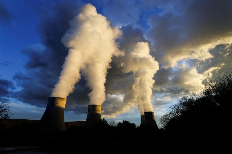FILE PHOTO: Steam rises from cooling towers of the Electricite