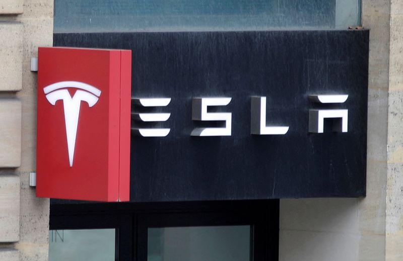 The logo of Tesla is seen on a store in