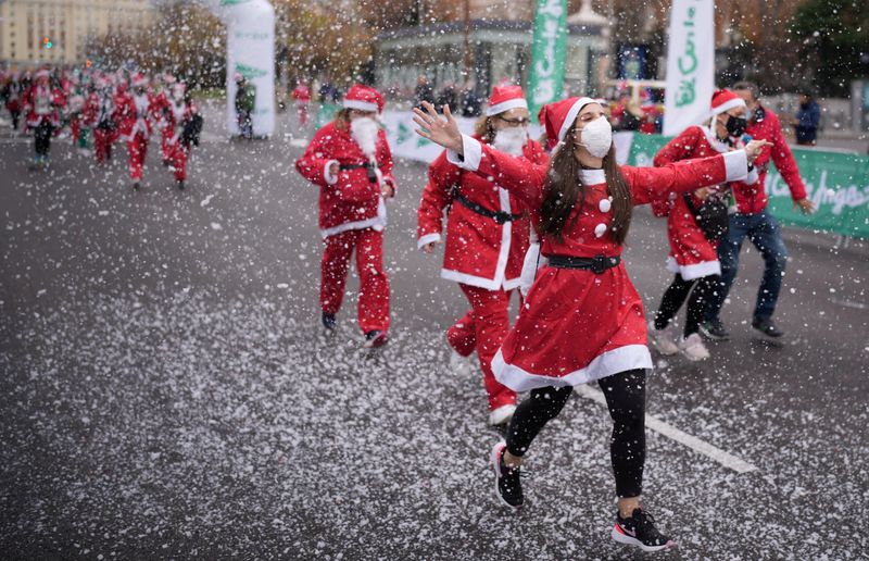 People dressed as Father Christmas get ready to run on