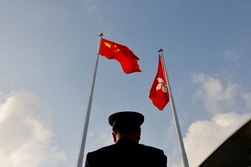 FILE PHOTO: A police officer stands guard below China and