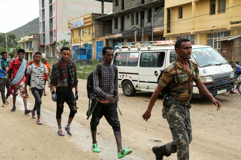 Newly recruited youth joining Tigrayan forces march through the village