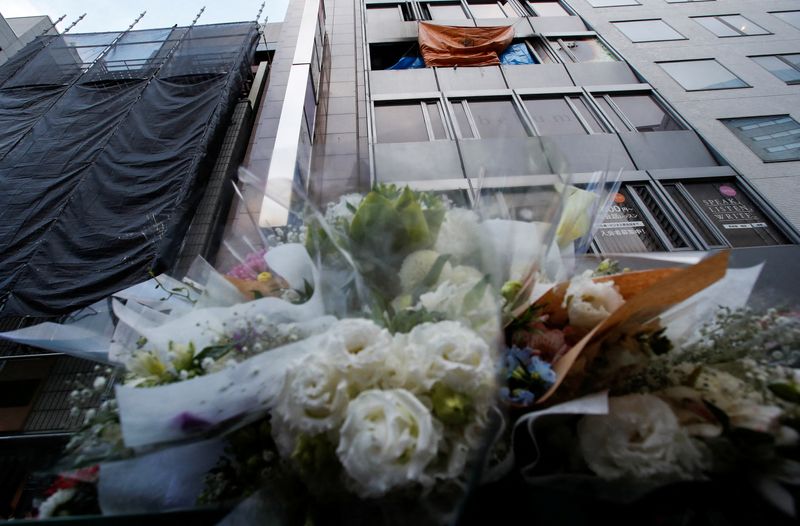 FILE PHOTO: Flowers are placed by the building where a
