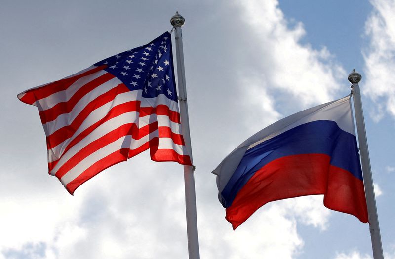 FILE PHOTO: Russian and U.S. state flags fly near a