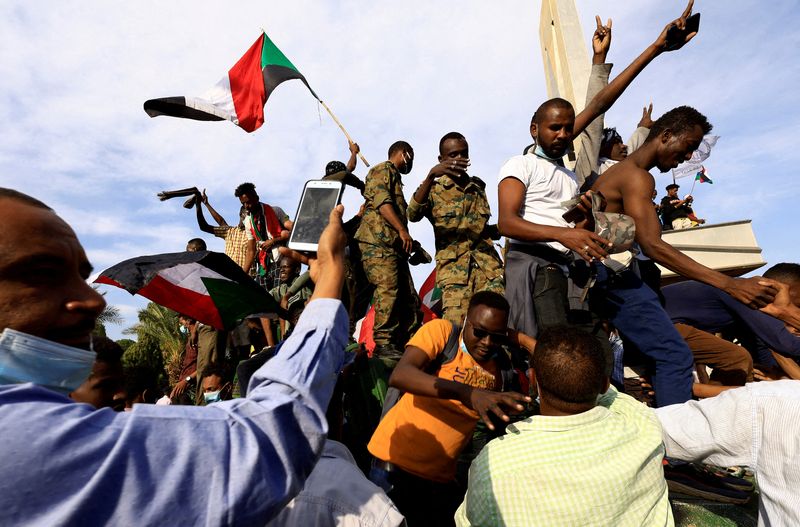 FILE PHOTO: Protesters celebrate reaching the presidential palace in Khartoum