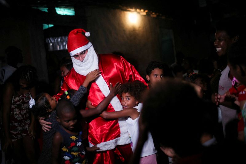 Santa Claus distributes distributes gifts to children during a Christmas
