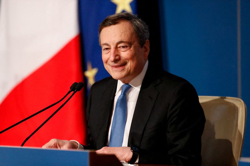 FILE PHOTO: Italian Prime Minister Mario Draghi holds his end-of-year
