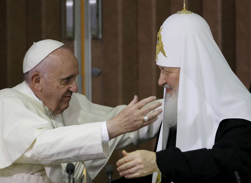 FILE PHOTO: Pope Francis, left, reaches to embrace Russian Orthodox
