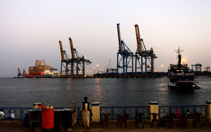FILE PHOTO: A man stands opposite the modern port at