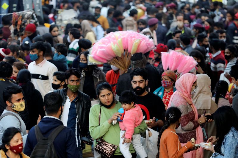 People shop at a crowded market ahead of Christmas during