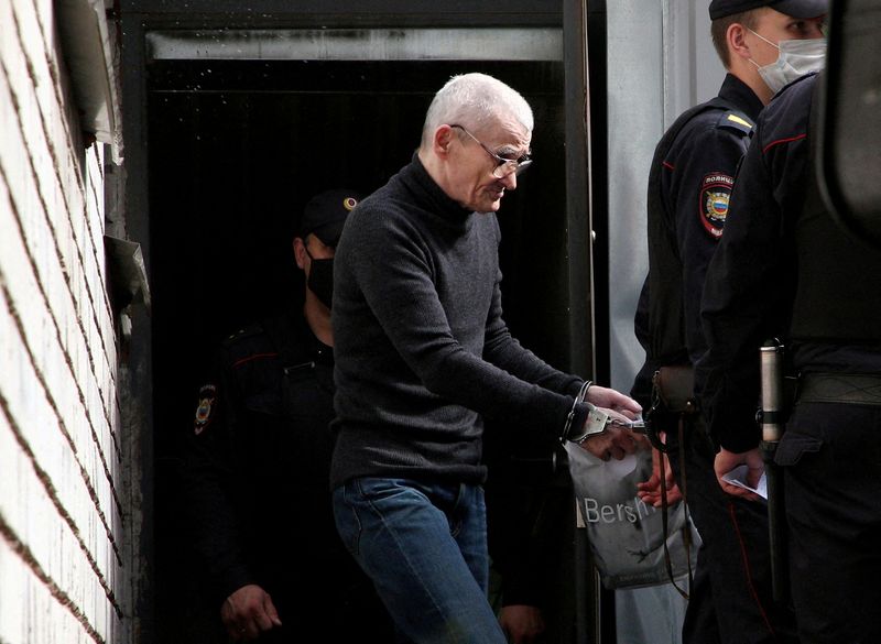 FILE PHOTO: Russian historian Yuri Dmitriev is escorted by police