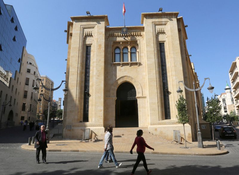 People walk outside the parliament building in downtown Beirut