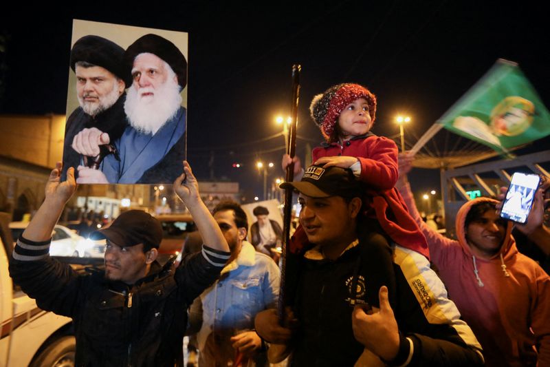 Iraqi supporters of Sadr’s movement celebrate after Iraq’s Supreme Court