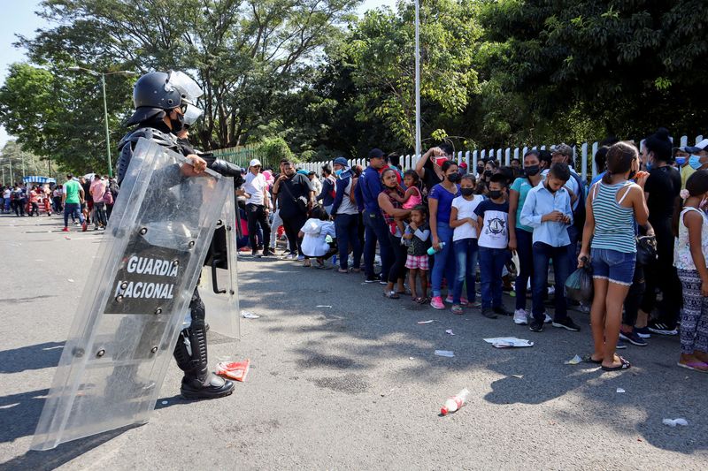 FILE PHOTO: Central American migrants form a line while they