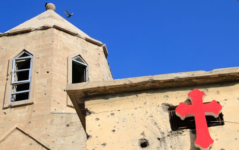 A cross is pictured at the wall of a church