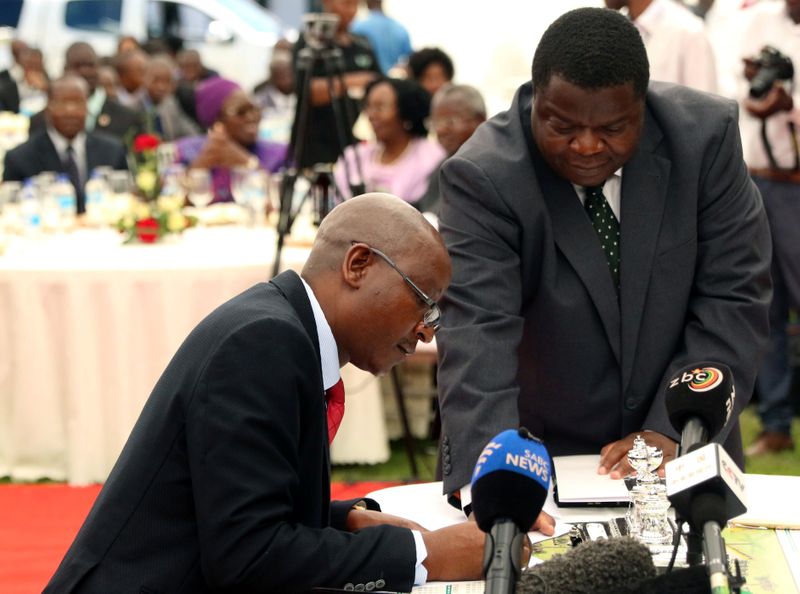 Zimbabwean Minister of Justice Ziyambi Ziyambi signs the oath of