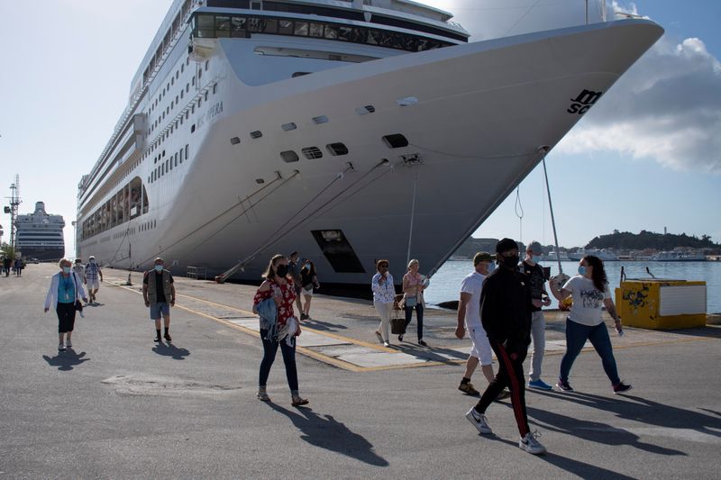 Passengers of the Costa Luminosa cruise ship wearing protective face