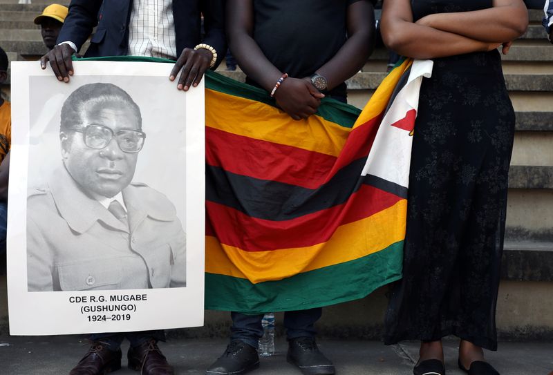 FILE PHOTO: Mourners hold a poster during the state funeral