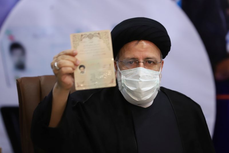 Ebrahim Raisi, Chief Justice of Iran, shows his identification document