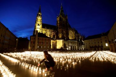 FILE PHOTO: People light candles to commemorate COVID-19 victims in