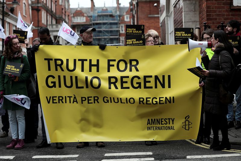 FILE PHOTO: Demonstrators from Amnesty International hold placards outside the