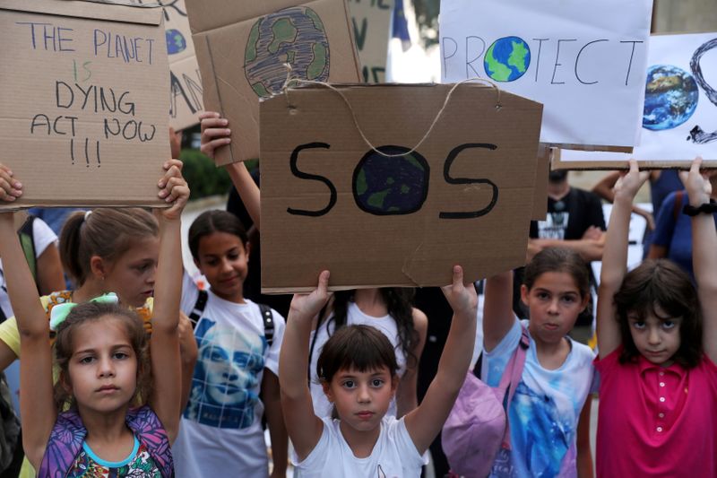 FILE PHOTO: Children hold placards during a global climate change