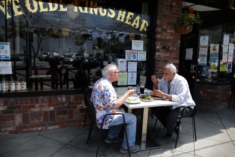 People eat at the King’s Head pub as Los Angeles