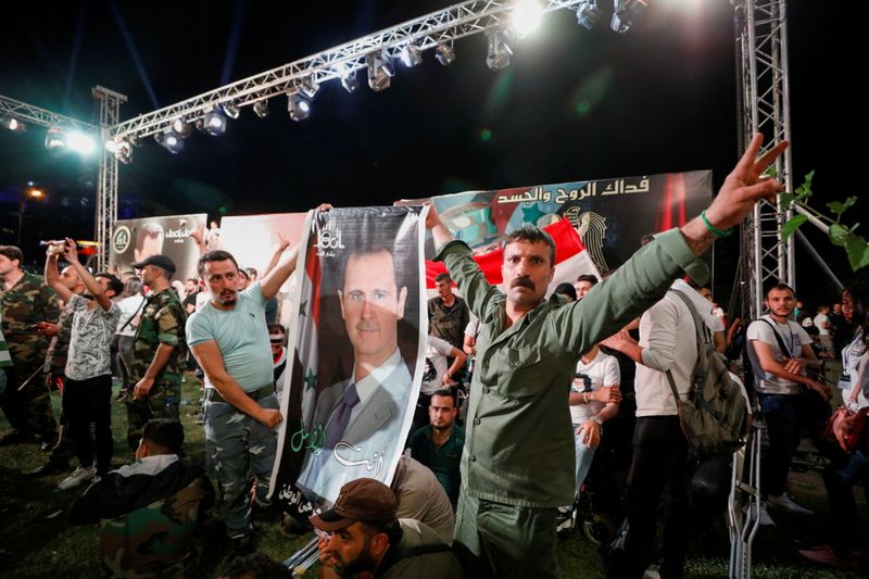 Supporters of Syria’s President Bashar al-Assad celebrate before the results