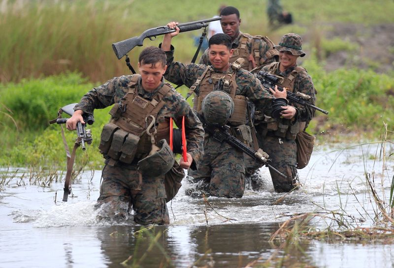 FILE PHOTO: U.S. military forces cross a flooded area near