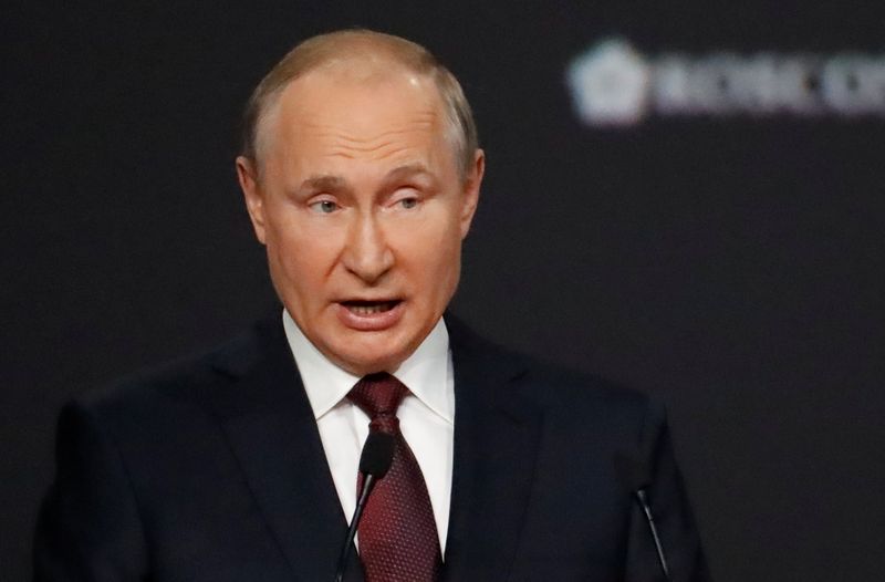 FILE PHOTO: Russian President Putin delivers a speech during a