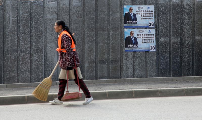 FILE PHOTO: A street cleaner carries a broom near election